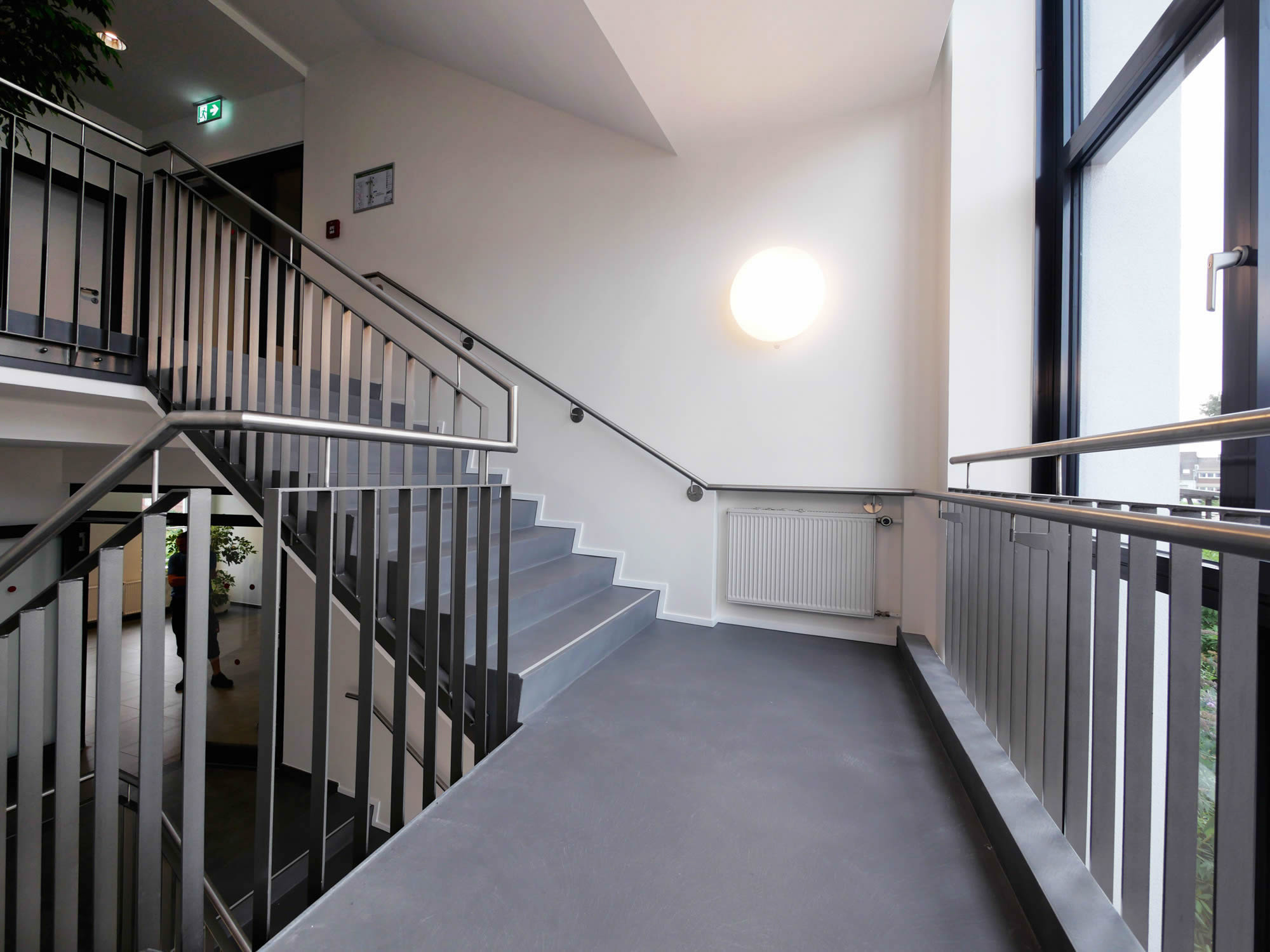 referenz_afa_coesfeld_treppenhaus_podest_stahlgelaender_grauer_boden